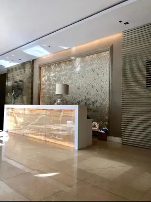 a lobby with a large glass wall in a building at Spacious Studio no balcony in Mosaic Tower with WiFi and Smart TV in Manila