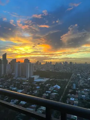 a view of a city skyline at sunset at Sunset View 1 BR with balcony FREE Pool&Gym Access in Manila