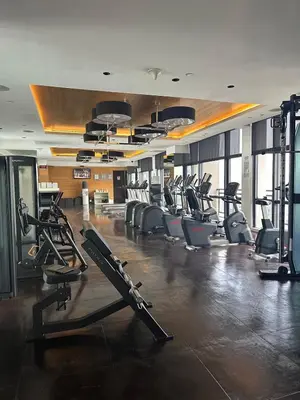 a gym with treadmills and ellipticals in a building at Sunset View 1 BR with balcony FREE Pool&Gym Access in Manila