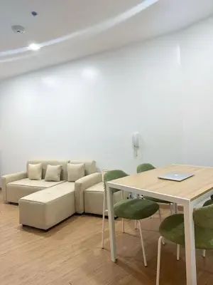 a living room with a couch and a table at Minimalist 1 Bedroom Sunset View in Gramercy in Manila