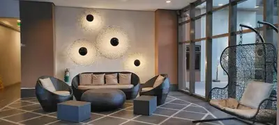 a living room with a couch and chairs at Cooper's Place in Manila
