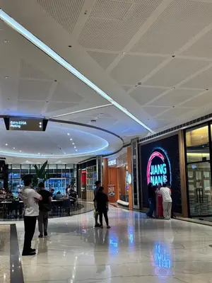 a group of people standing in a shopping mall at Stylish City Escape in Manila