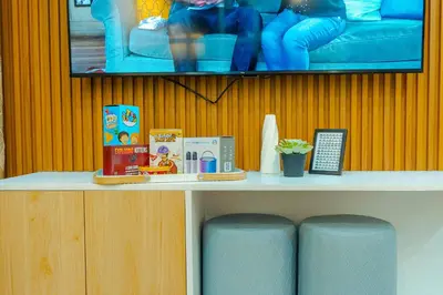 a shelf with books and other items on it at Consider It Yours - Stay Cozy with City Views in Manila