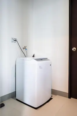 a white refrigerator with a faucet on top of it at Uptown Parksuites Upscale Spacious Cor Unit Balcony and Views in Manila