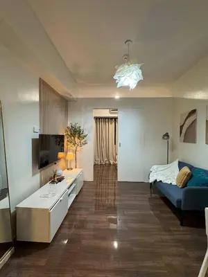 a living room with a couch and a bed and a television at Entire Room in Makati Center with FAST WIFI in Manila