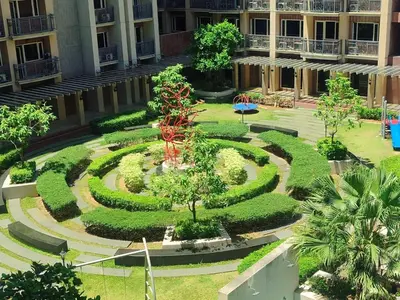 a garden in the middle of a building at Condo MOA with pool access WS811 in Manila