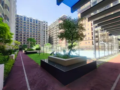 a park with a tree in the middle of a city at Condo MOA with pool access WS811 in Manila