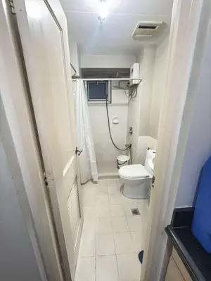 a small bathroom with a toilet and a sink at La verti 1BR Affordable staycation for family groups in Manila