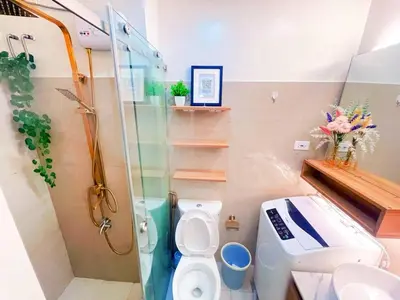 a bathroom with a shower and a toilet and a sink at shore 2 tower 3 near moa in Manila
