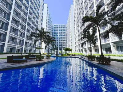 a large swimming pool in a city with tall buildings at shore 2 tower 3 near moa in Manila