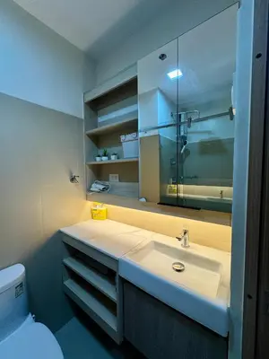 a bathroom with a sink and a toilet and a mirror at Jays BnB in Manila