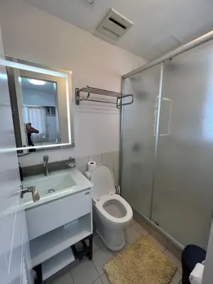 a bathroom with a toilet and a sink and a shower at Angel's Place Torre De Manila, Cozy 1BR Condo, Sunset View Near all Attractions in Manila