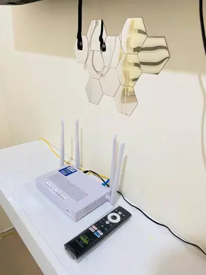 a laptop computer sitting on a table with a remote control at Fully Furnished Studio Type Room for Rent Can be long term or short term in Manila