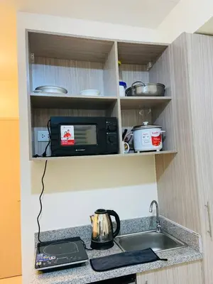 a kitchen counter with a sink and a microwave at Fully Furnished Studio Type Room for Rent Can be long term or short term in Manila