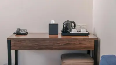 a wooden table with a coffee maker on top of it at City Getaway in the Heart of Entertainment City in Manila