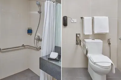 a bathroom with a toilet and a shower at City Getaway in the Heart of Entertainment City in Manila
