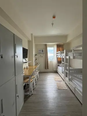a room with a dining table and bunk beds at Jac's Hide Out 5 in Manila