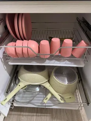 a drawer filled with pink plates and bowls at Jac's Hide Out 5 in Manila