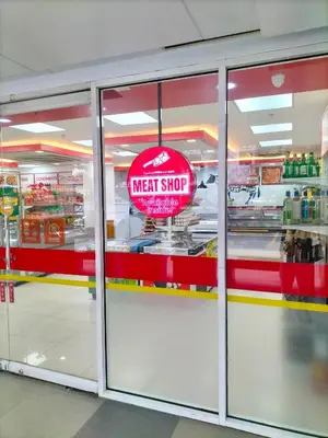 a store with a meat shop sign in the window at Shell Residences MOA - Josh staycation in Manila