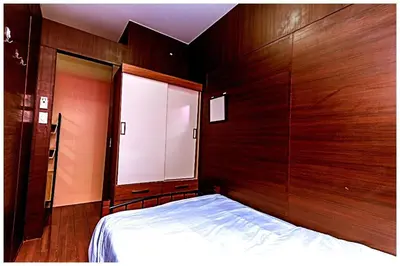 a bedroom with a bed and a wooden wall at 2 bedroom fantastic air condo 3649 swim gym surf 300 MB in Manila