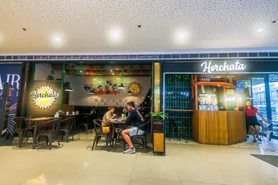 a group of people sitting at tables in a restaurant at 2 Bedroom Green Yellow luxury 5549 Makati 300Mb swim in Manila