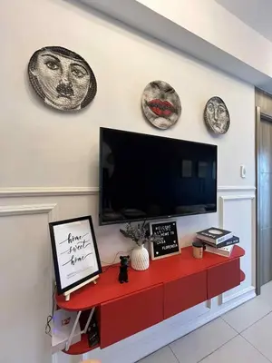 a living room with a flat screen tv on a wall at Casa Florencia at SDMC Coast Residences in Manila
