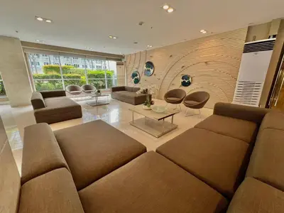 a living room with a couch and chairs and a table at Studio Condo by Sea Residences near MOA 03 in Manila