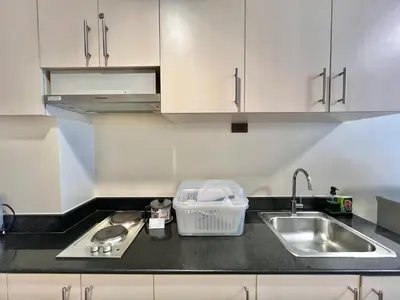 a kitchen with a sink and a counter top at Studio Condo by Sea Residences near MOA 03 in Manila