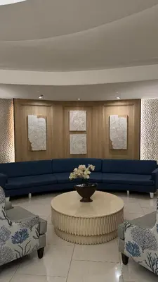 a living room with a blue couch and a table at Spacious Condo at Shell Residences, MOA Pasay - The Urban Stay in Manila