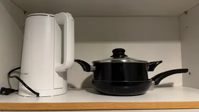a tea kettle and a toaster on a kitchen counter at Spacious Condo at Shell Residences, MOA Pasay - The Urban Stay in Manila