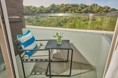 a chair sitting on a balcony with a window at Sea View older in Manila