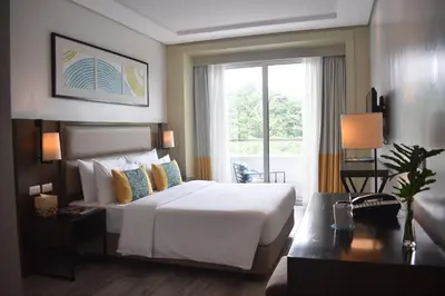 a hotel room with a bed and a window at Sea View older in Manila