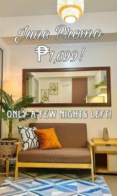 a living room with a couch in front of a mirror at 15 Mins Away from NAIA Perfect for Staycation in Manila