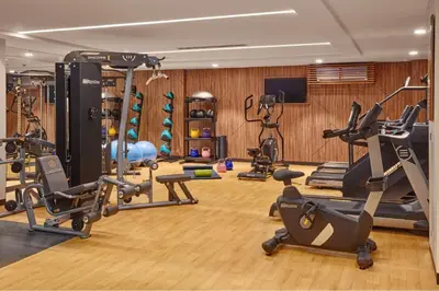 a gym with several exercise equipment in a room at Modern City Stay Near Manila Bay Attractions in Manila