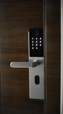 a door lock with a remote control on it at Smart Cozy Home Air Residences Makati 4125 in Manila