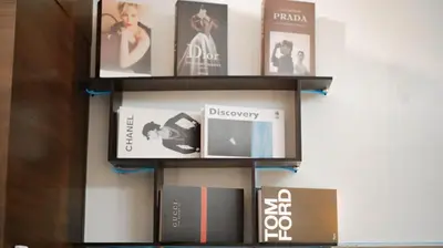 a book shelf filled with books on a wall at Smart Cozy Home Air Residences Makati 4125 in Manila