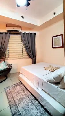 a bedroom with a bed and a window at Urban Retreat at Shell Residences with Netflix 300mbps Wifi in Manila