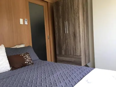 a bedroom with a bed and a door to a closet at Urban Retreat at Shell Residences with Netflix 300mbps Wifi in Manila