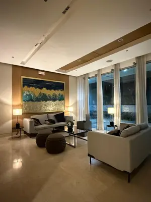 a living room with couches and tables and windows at Obetskie's Haven Condotel in Manila