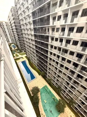 an aerial view of a large apartment building with a swimming pool at Obetskie's Haven Condotel in Manila