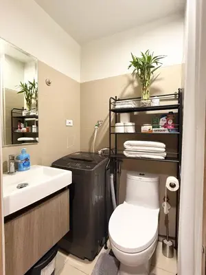 a bathroom with a toilet and a sink at Obetskie's Haven Condotel in Manila