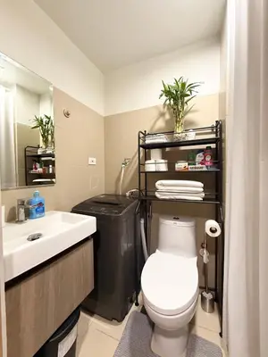 a bathroom with a white toilet and a sink at Obetskie's Haven Condotel in Manila