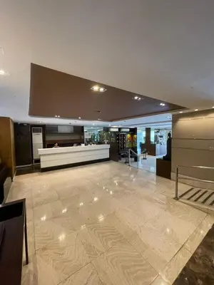a large room with a lobby with a counter at A Venue Residences 9133 in Manila