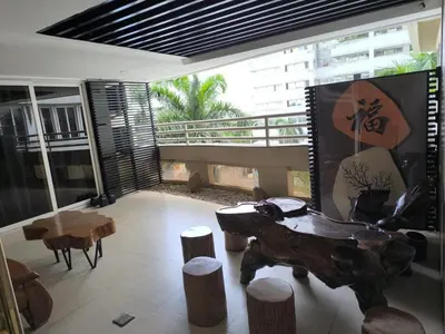 a living room with a wooden table and some stools at R&R Entire Rental Unit in Manila