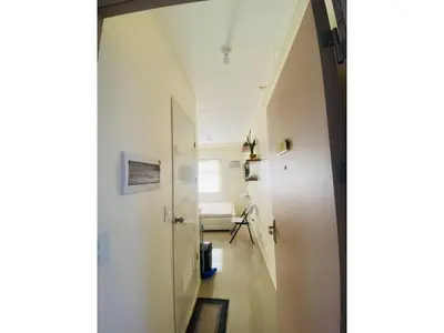 a hallway leading to a room with a bed at Fully Furnished Condo for Rent in Manila