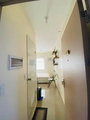 a room with a hallway with a door and a window at Fully Furnished Condo for Rent in Manila