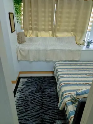 a bedroom with a bed and a window with a windowtaining at South Residence Condo Las Pinas, Manila in Manila