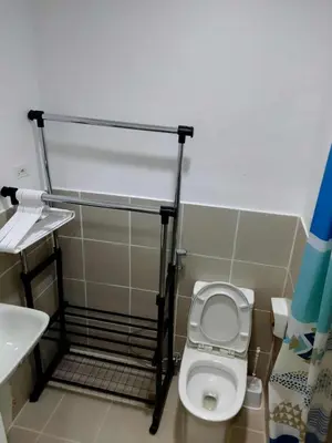 a small bathroom with a toilet and a sink at South Residence Condo Las Pinas, Manila in Manila
