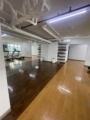 an empty room with a wooden floor and white walls at Makati City Antel Spa Residences 2707 in Manila