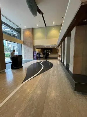 an empty lobby of a building with people walking around at Makati City Antel Spa Residences 2707 in Manila